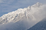 A paraglider flying high in the French Alps above Chamonix.